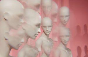 collection of Tribe female mannequin heads on a pink background