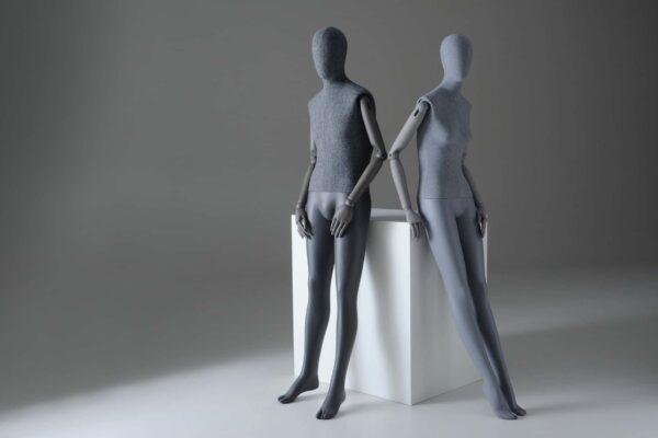 Male and female Sartorial mannequins leaning against a plinth