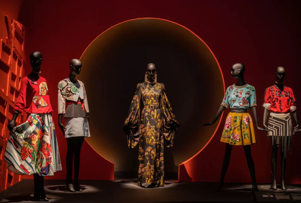 Dressed Schläppi female mannequins on a stage with a red background