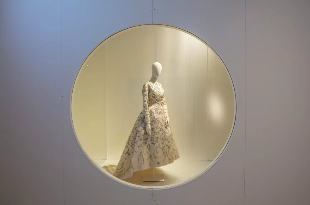 a mannequin with a cream Balenciaga dress staged in a round window