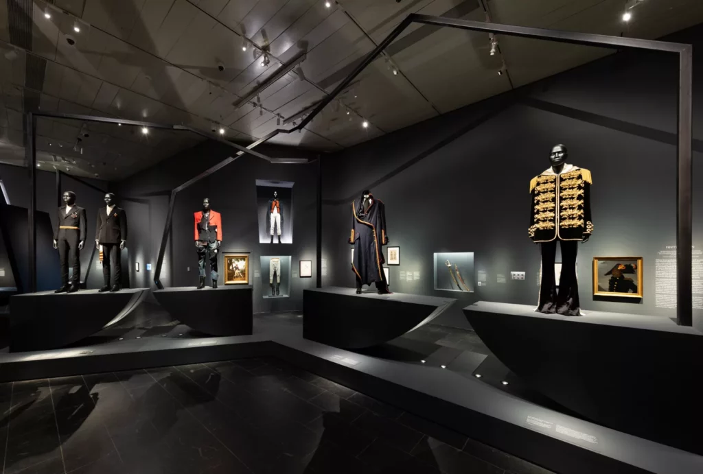 A series of mannequins on platforms in a gallery