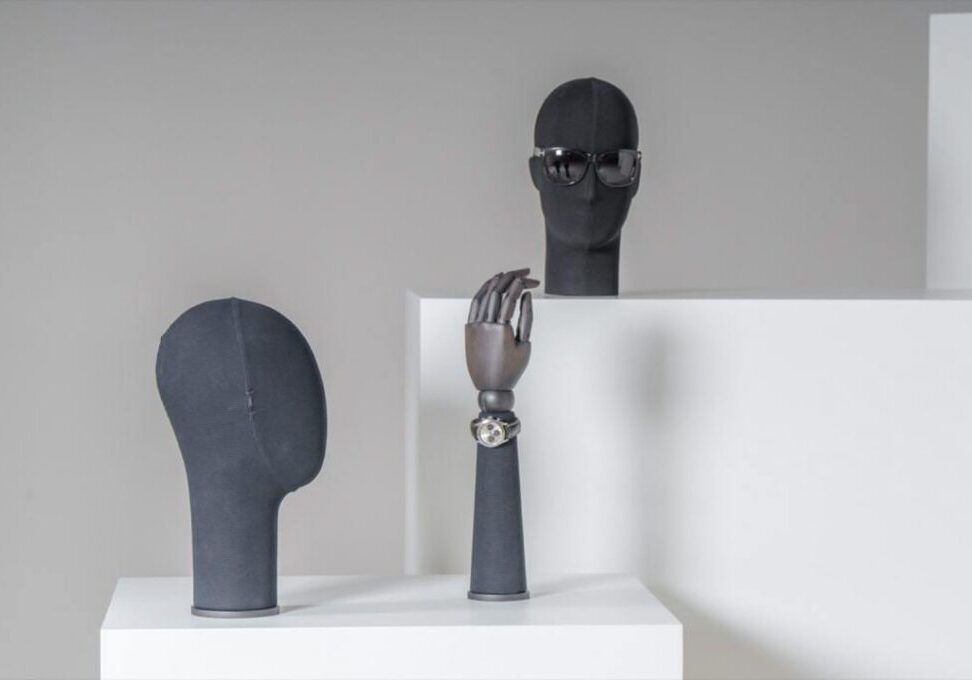 Male display heads and hands in dark fabric