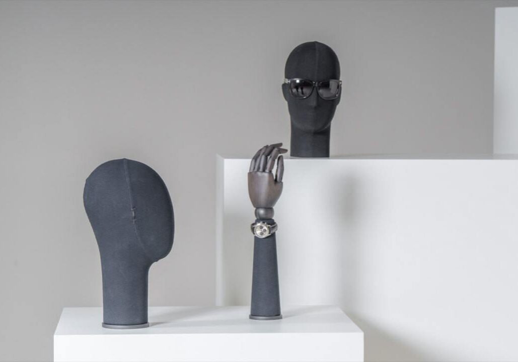 Male display heads and hands in dark fabric