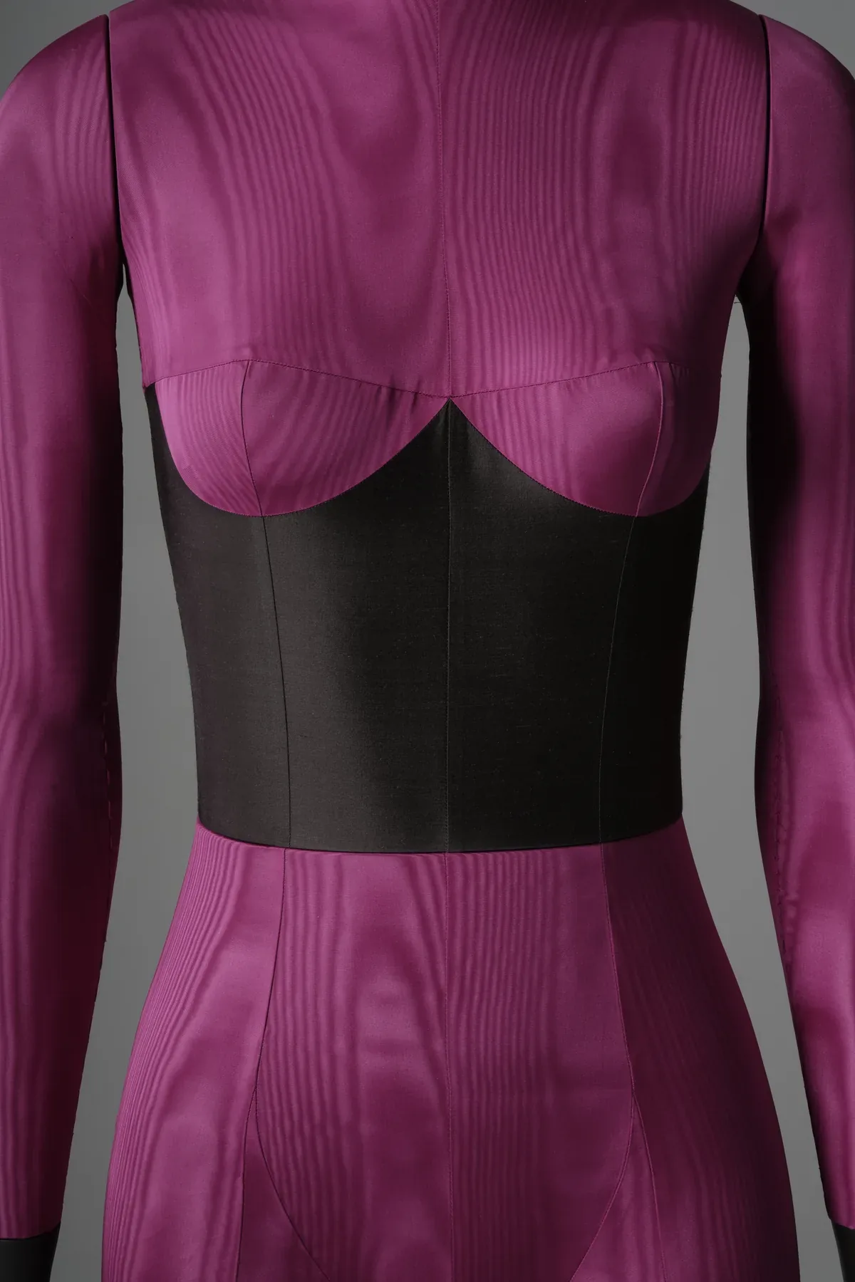 Front torso close-up of the magenta moire catsuit bespoke mannequin showing the black corset panel with sweetheart outline