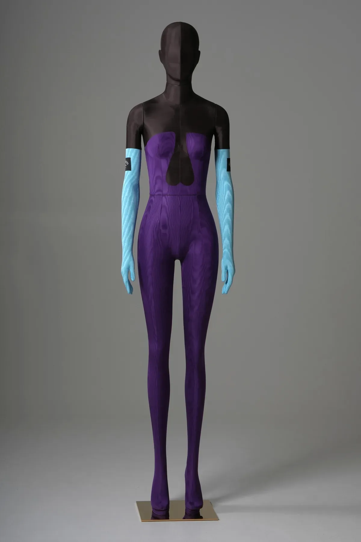Full-length front view of the Bonaveri Sartorial Bespoke mannequin in magenta moire catsuit with black corset panel and Bonaveri label