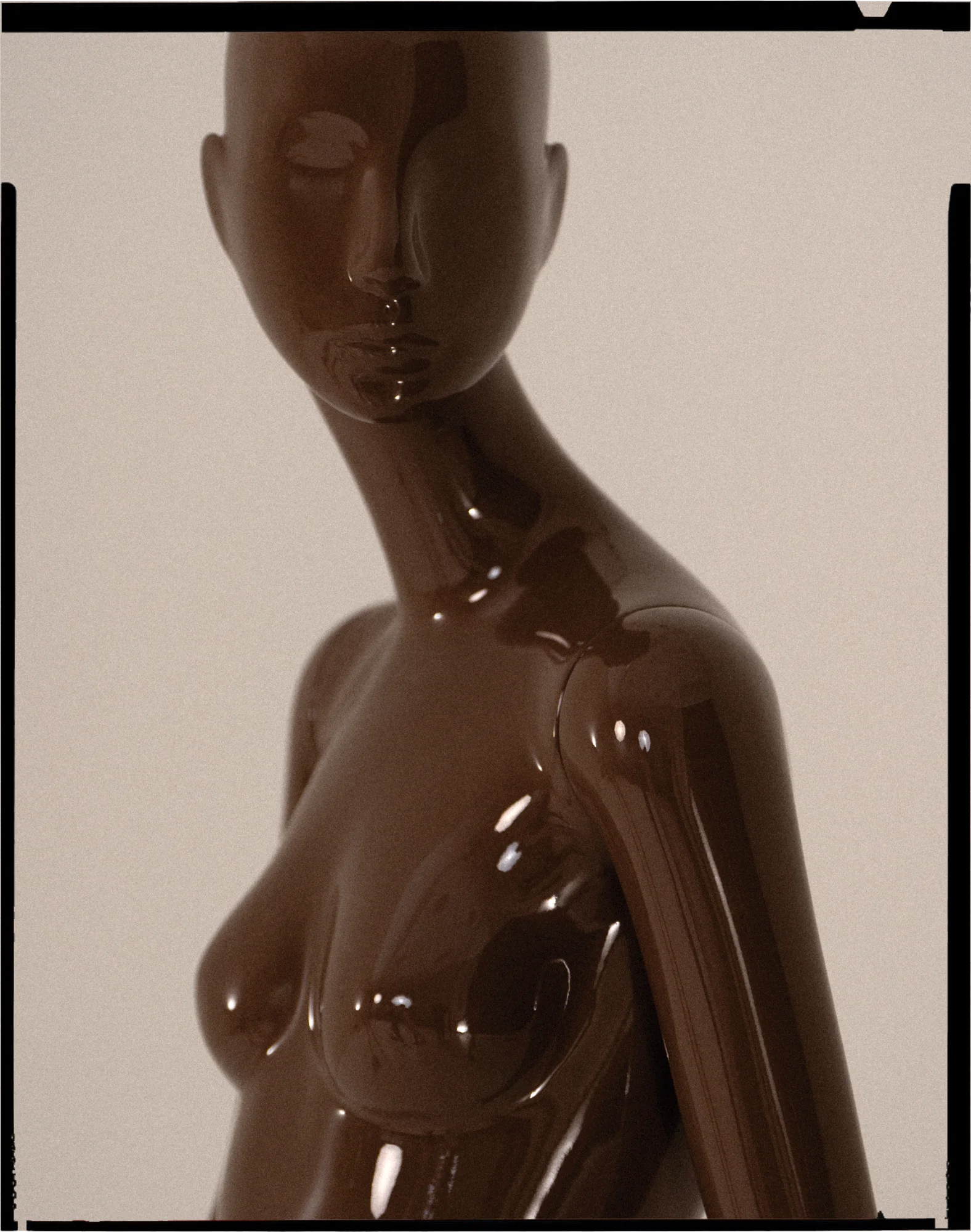 Gloss brown Obsession mannequin bust, framed like a film negative