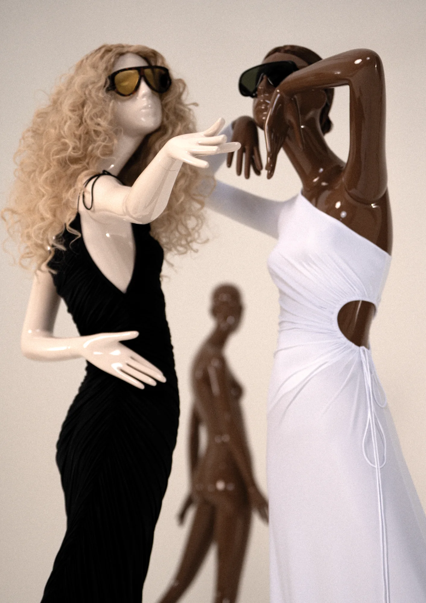 Two gloss Obsession mannequins in black and white dresses, a third behind