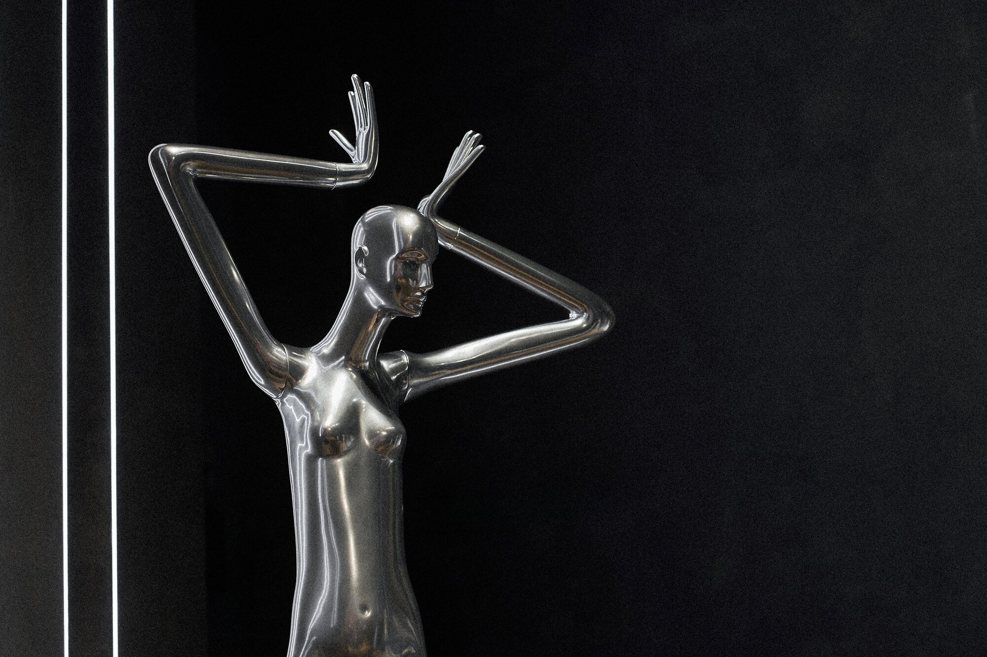 Chrome Schläppi Obsession mannequin with arms raised against a black wall lit by white light strips