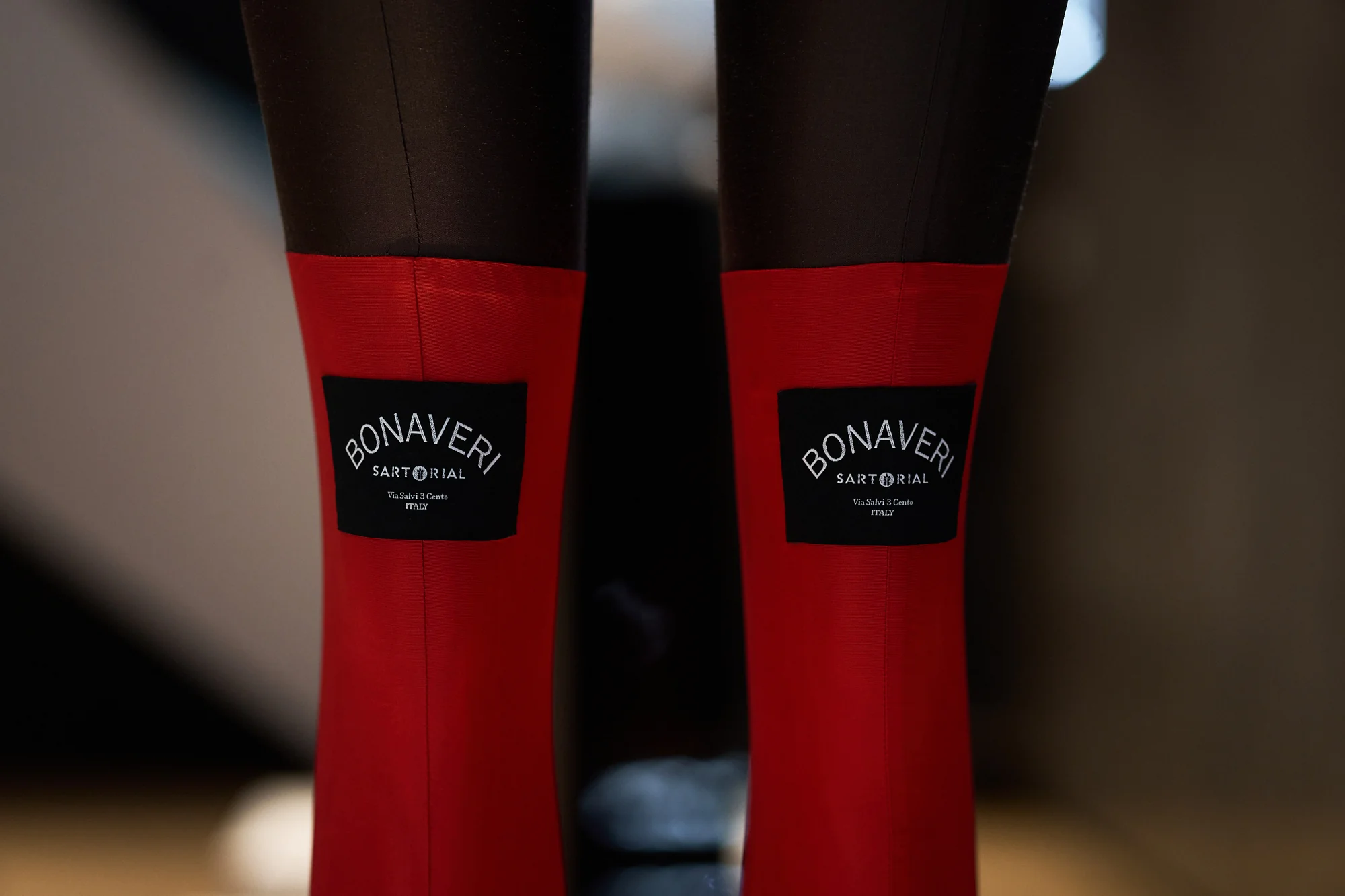Close-up of a mannequin's legs in red stockings with Bonaveri Sartorial labels