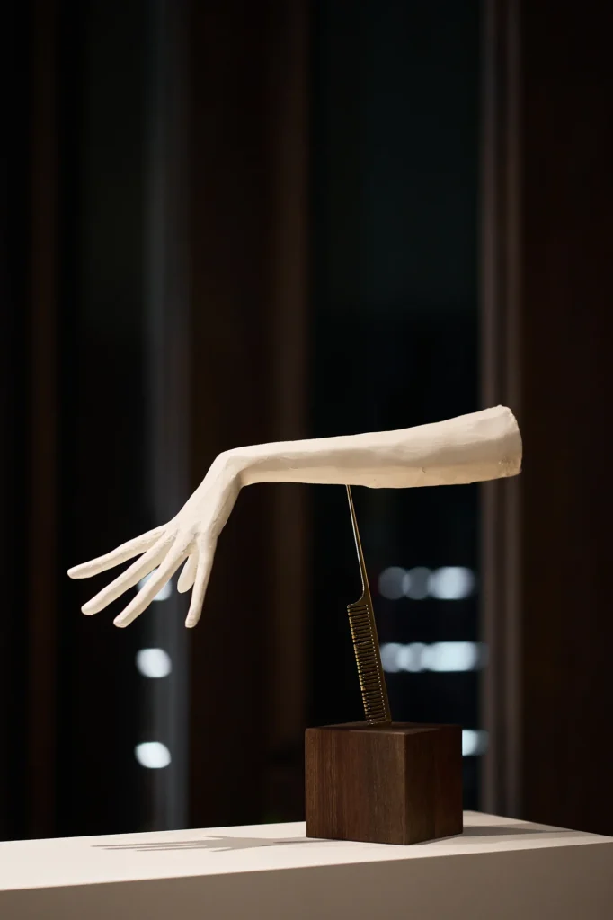 White sculpted arm on a wooden block